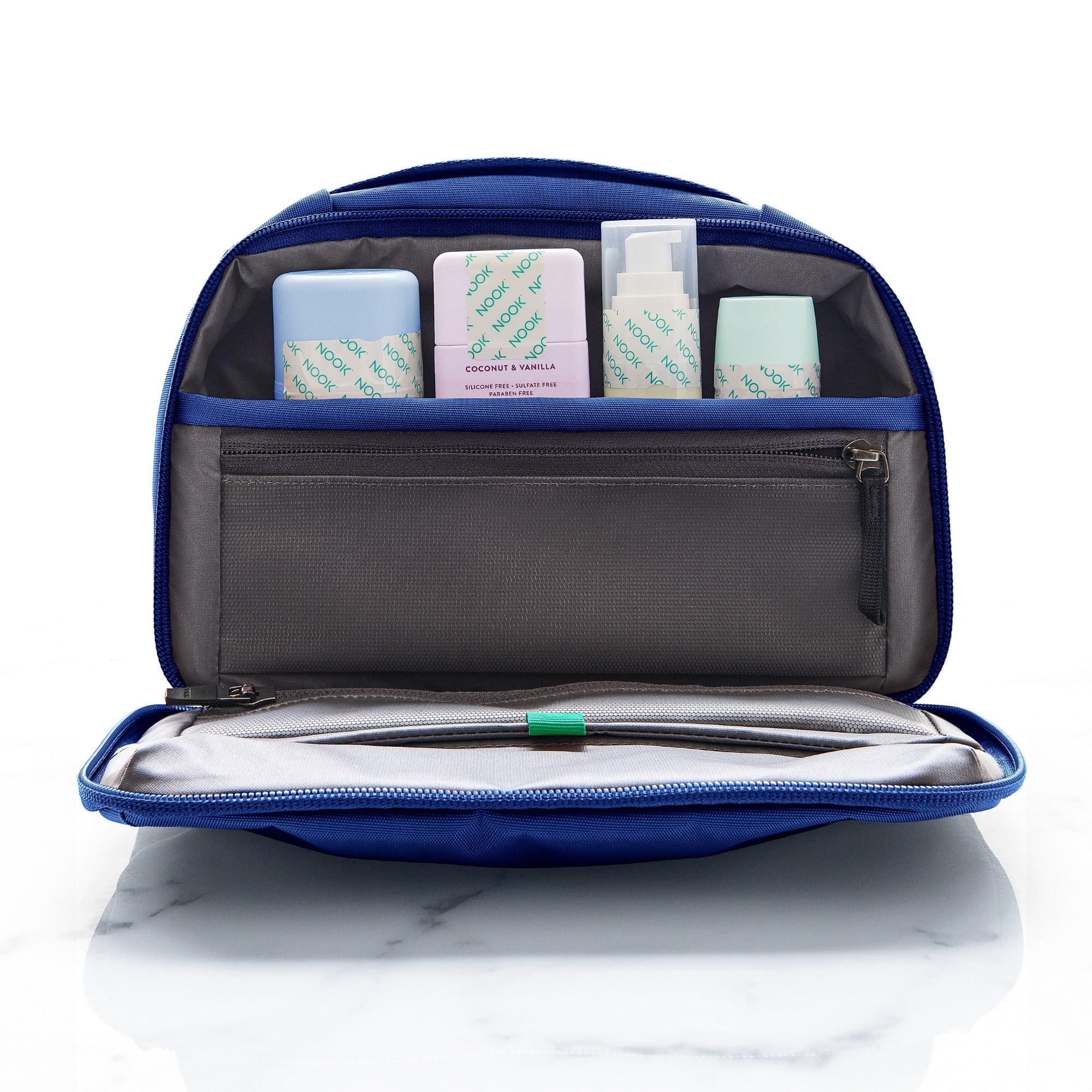 Open travel toiletry bag with bottles sealed using NOOK Toiletry Tape