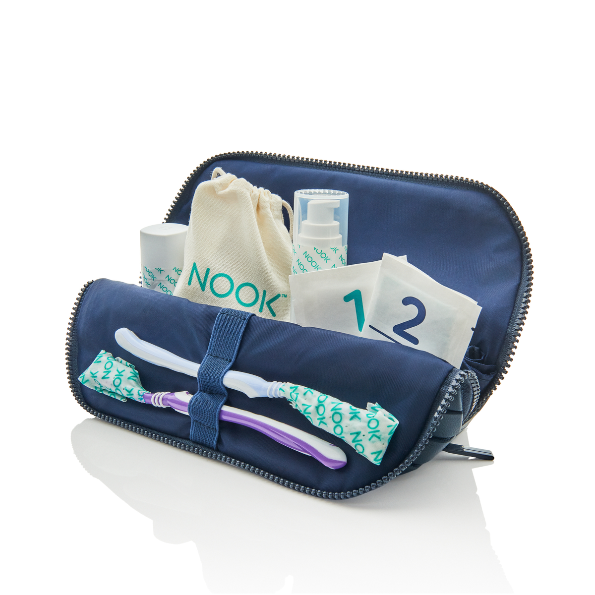 NOOK Wraps travel kit in a navy toiletry bag with numbered wrap sleeves, a wrapped toothbrush, and travel bottles